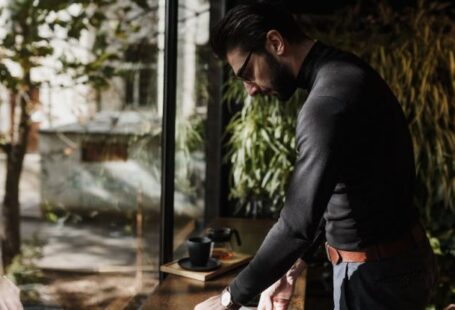 Smart Windows - Elegant Man Standing neat to a Table in a Cafe and Collecting His Things