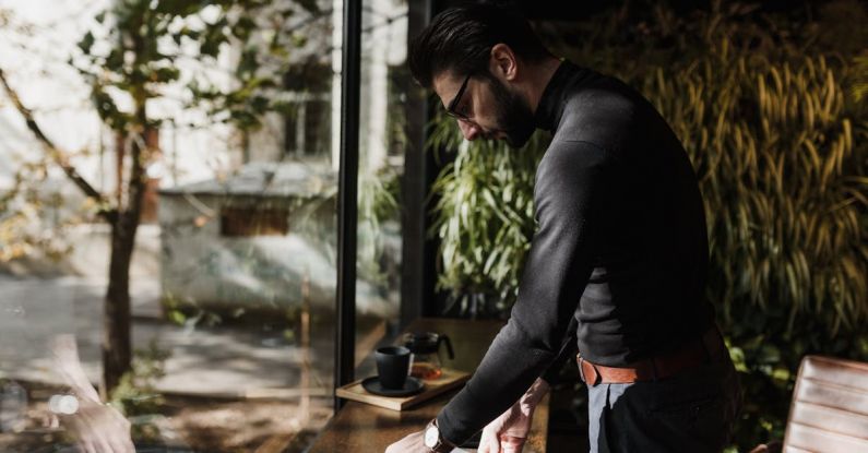 Smart Windows - Elegant Man Standing neat to a Table in a Cafe and Collecting His Things