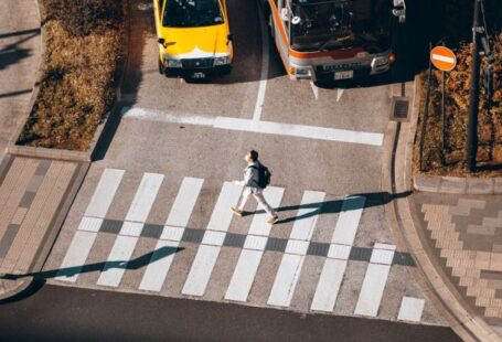 Automated Vehicles - A person is crossing the street in front of a bus